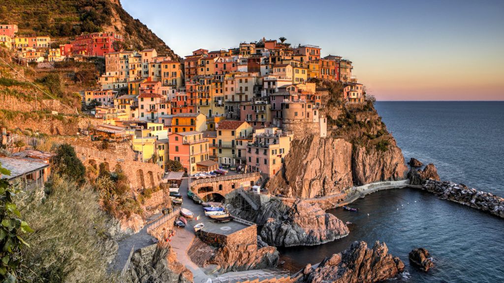 A colorful village overlooking a body of water.